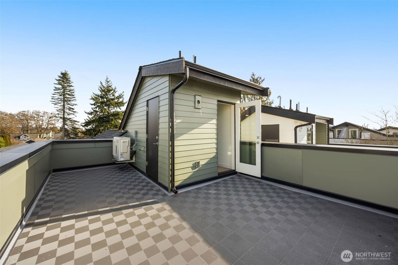 The private roof deck, plumbed for gas and water, looking west over the rooftops